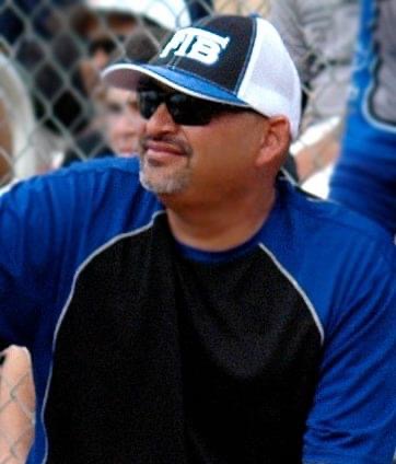 A man in a baseball cap and sunglasses.